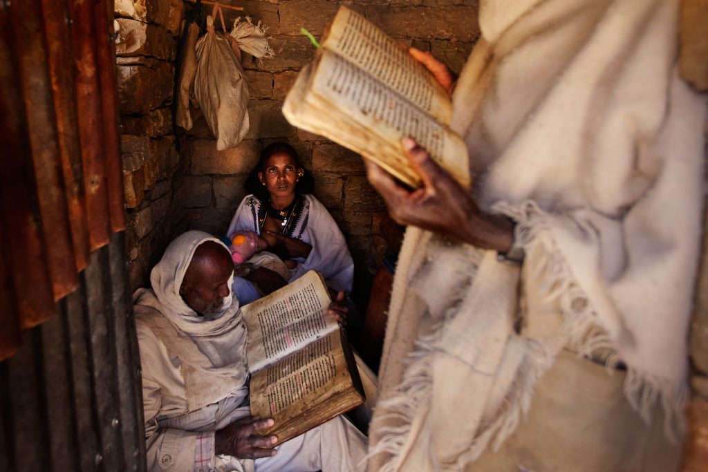 Priests-reading-prayers-during-a-baptism-in-a-small-countryside-church-in-Enderta-area,-Tigray
